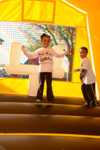 girl bouncing in yellow bounce house